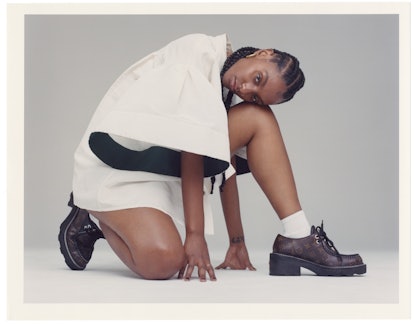 Mereba posing in a white Carolina Herrera shirt and Louis Vuitton shoes. 