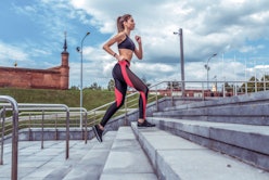 Sports girl runs in summer in city. Sportswear Leggings Top. Cloud stair background. Motivation for ...