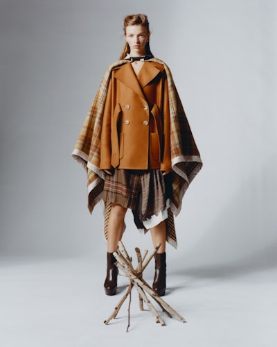 Model wearing Lanvin coats, skirt; Jennifer Fisher earrings; Stuart Weitzman boots.