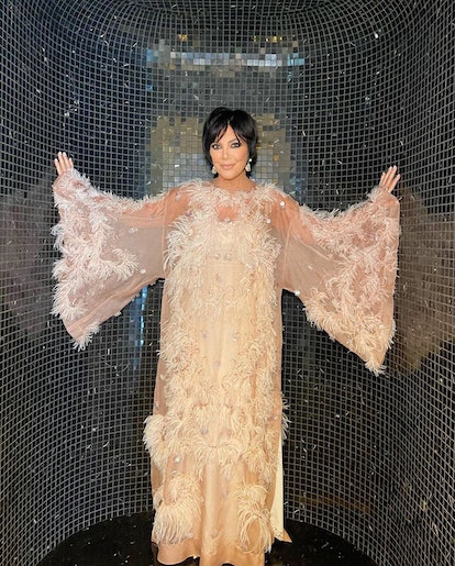 Kris Jenner posing in a white gown