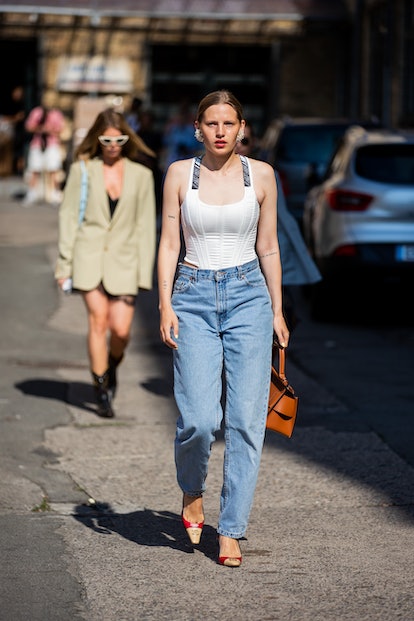 I AM GIA white corset with jeans in street style.