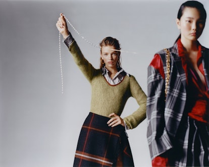 Two models wear Salvatore Ferragamo knit sweater, shirt, skirt; Hannah Jewett earrings. Marni jacket...