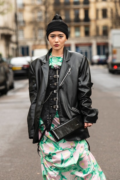 Leather corset worn under a leather jacket in street style.