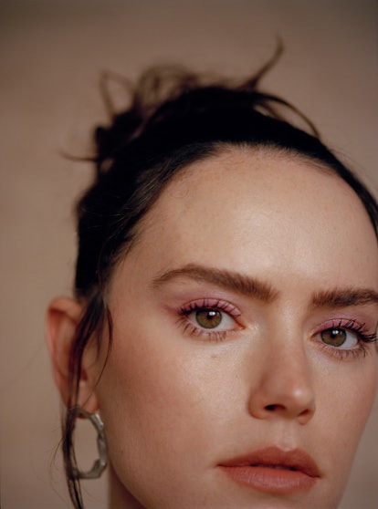 A closeup of TZR cover star Daisy Ridley wearing pink eyeliner