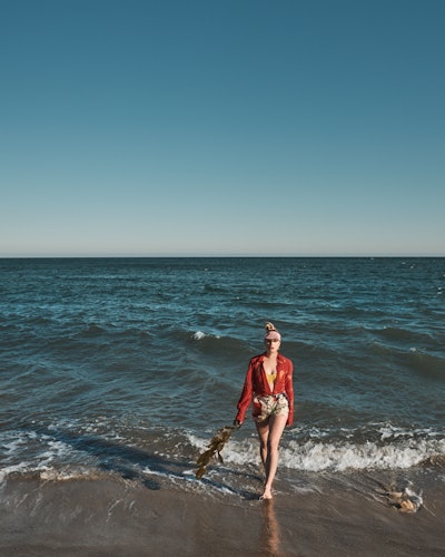 Annie Murphy, star of 'Schitt's Creek' & 'Kevin Can F*ck Himself,' stands in the water at the beach ...