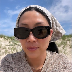 Kathy Lee wearing sunglasses and a head scarf for sun protection