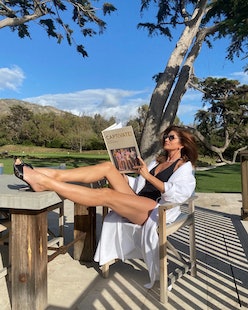 Cindy Crawford wears a black swimsuit