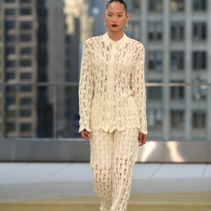 a model wearing a crochet shirt and pants on the Jonathan Simkhai Spring/Summer 2022 runway