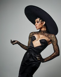 Michaela Jaé Rodriguez poses in a black Gucci dress and oversized hat on the set of her cover photo ...