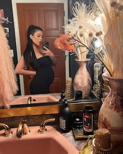 Kourtney Kardashian pregnant belly and long ponytail