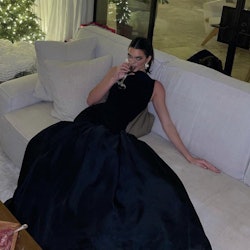 Kendall Jenner sitting in a black gown