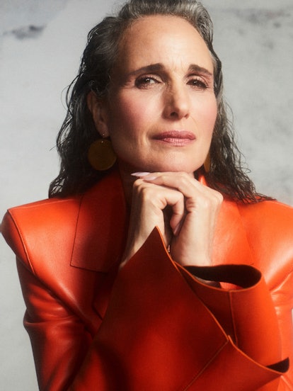 A close-up image of TZR cover star Andie MacDowell with her hands beneath her chin wearing an Off-Wh...