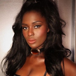 Jodie Turner-Smith long blowout curls and bustier